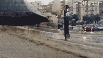 Crossing A Street During A Flood